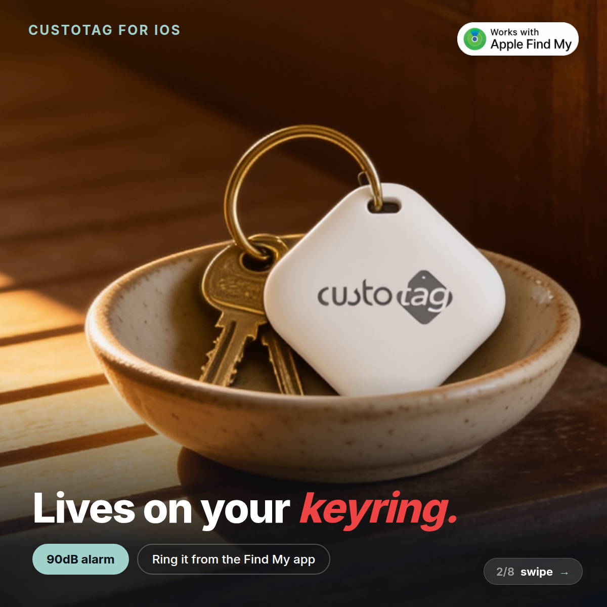 CustoTag for iOS on a keyring with house keys in a bowl. 90dB alarm, ring it from the Find My app.